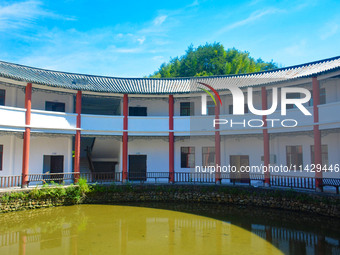 A square building and a round building are being seen in Maojianshan township, Yuexi County, in Anqing, China, on July 22, 2024. (