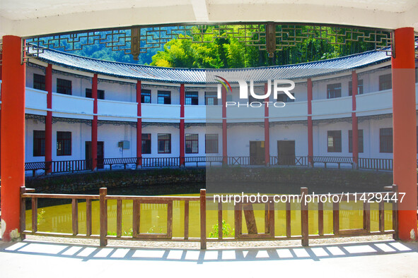 A square building and a round building are being seen in Maojianshan township, Yuexi County, in Anqing, China, on July 22, 2024. 