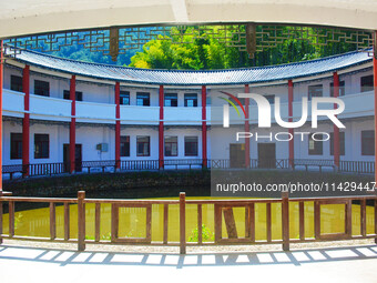 A square building and a round building are being seen in Maojianshan township, Yuexi County, in Anqing, China, on July 22, 2024. (