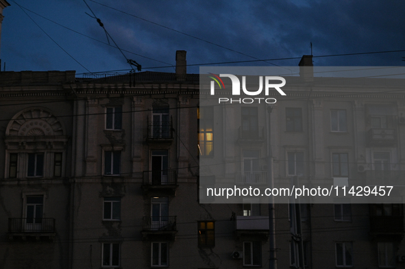 A single window is being illuminated at night as the city is switching off street lights due to power shortages in the region and to save el...