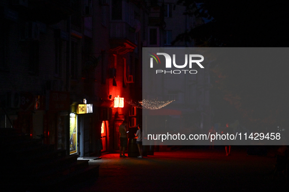 A dark street is being seen at night as the city is switching off street lights due to power shortages in the region and to save electricity...