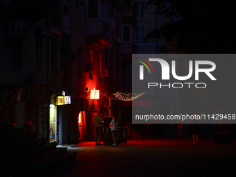 A dark street is being seen at night as the city is switching off street lights due to power shortages in the region and to save electricity...