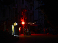 A dark street is being seen at night as the city is switching off street lights due to power shortages in the region and to save electricity...