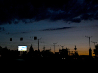 A screen is being seen on the dark screen at night as the city is switching off street lights due to power shortages in the region and to sa...