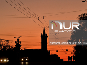 Cars are moving along a road at sunset as the city is switching off street lights due to power shortages in the region and to save electrici...