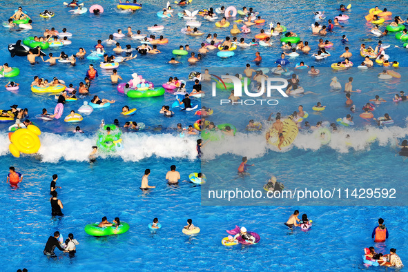 Citizens are cooling off at a water park in Nanjing, China, on July 23, 2024. 