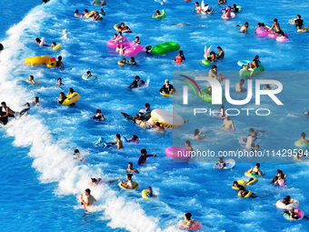 Citizens are cooling off at a water park in Nanjing, China, on July 23, 2024. (