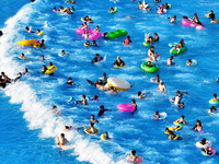 Citizens are cooling off at a water park in Nanjing, China, on July 23, 2024. (