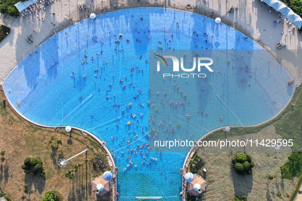 Citizens are cooling off at a water park in Nanjing, China, on July 23, 2024. 