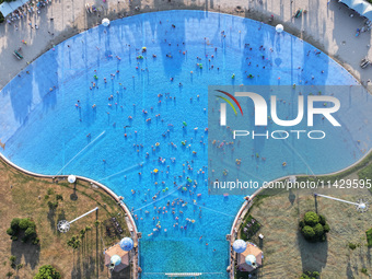 Citizens are cooling off at a water park in Nanjing, China, on July 23, 2024. (