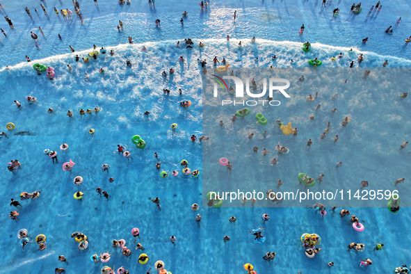 Citizens are cooling off at a water park in Nanjing, China, on July 23, 2024. 