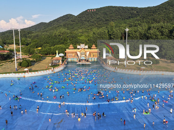 Citizens are cooling off at a water park in Nanjing, China, on July 23, 2024. (