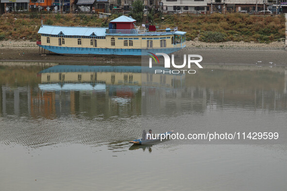 A man is fishing on the waters of river Jhelum as the dry spell is continuing in Srinagar, Jammu and Kashmir, on July 23, 2024. A prolonged...