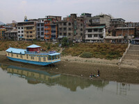 Men are fishing on the dried portion of the river Jhelum as the dry spell is continuing in Srinagar, Jammu and Kashmir, on July 23, 2024. A...