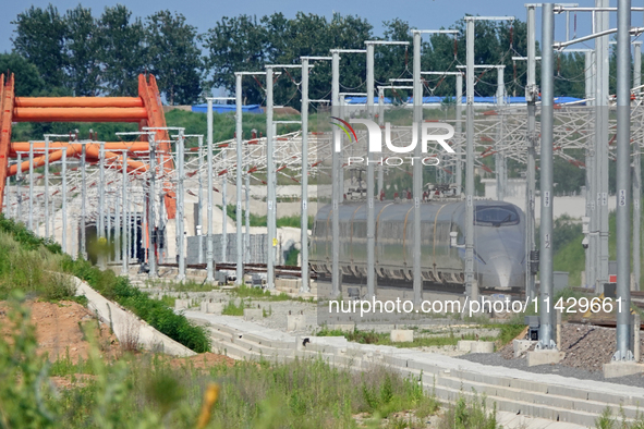 A high-speed comprehensive inspection train is running on the Penglai section of Weifang High-speed Railway in Yantai, China, on July 23, 20...