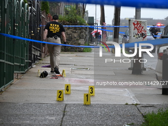 Evidence markers are being placed at the scene of the fatal shooting of a 28-year-old male in the Bronx, New York. A 28-year-old male victim...