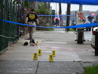 Evidence markers are being placed at the scene of the fatal shooting of a 28-year-old male in the Bronx, New York. A 28-year-old male victim...