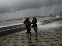 Visitors are reacting to sea waves at the Marine Drive promenade during high tide in Mumbai, India, on July 23, 2024. (