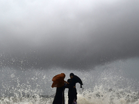 Visitors are reacting to sea waves at the Marine Drive promenade during high tide in Mumbai, India, on July 23, 2024. (