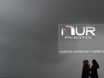 Visitors are reacting to sea waves at the Marine Drive promenade during high tide in Mumbai, India, on July 23, 2024. (