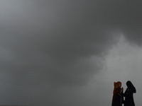 Visitors are reacting to sea waves at the Marine Drive promenade during high tide in Mumbai, India, on July 23, 2024. (