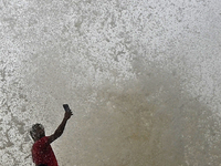 Visitors are reacting to sea waves at the Marine Drive promenade during high tide in Mumbai, India, on July 23, 2024. (