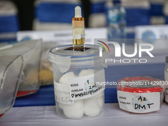 Indonesian National Narcotic Agency (BNN) officers are displaying evidence after a raid of a drug lab, during a press conference in Gianyar,...