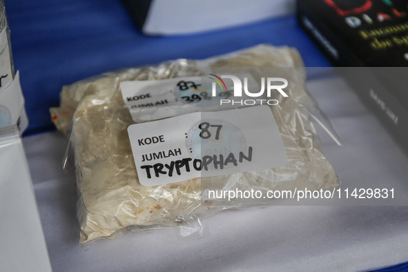 Indonesian National Narcotic Agency (BNN) officers are displaying evidence after a raid of a drug lab, during a press conference in Gianyar,...