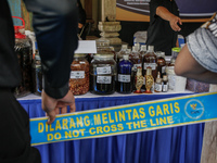 Indonesian National Narcotic Agency (BNN) officers are displaying evidence after a raid of a drug lab, during a press conference in Gianyar,...