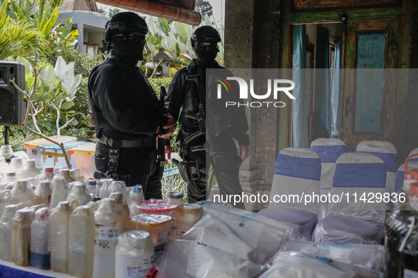 Indonesian National Narcotic Agency (BNN) officers are displaying evidence after a raid of a drug lab, during a press conference in Gianyar,...