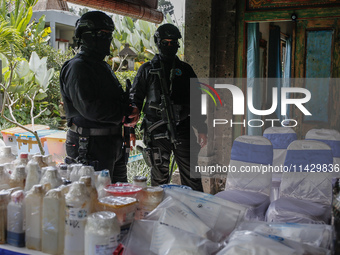 Indonesian National Narcotic Agency (BNN) officers are displaying evidence after a raid of a drug lab, during a press conference in Gianyar,...