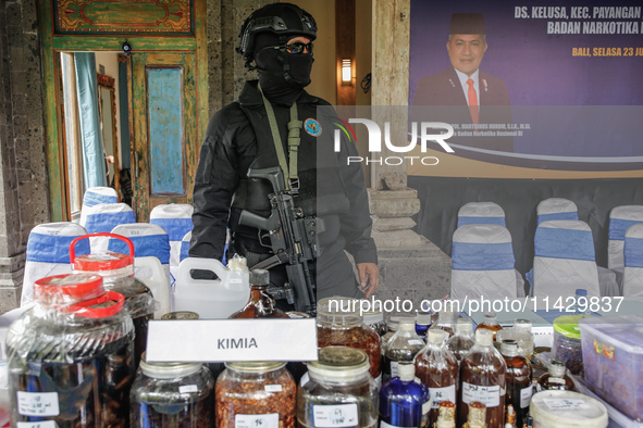 Indonesian National Narcotic Agency (BNN) officers are displaying evidence after a raid of a drug lab, during a press conference in Gianyar,...