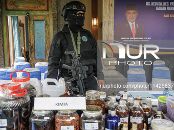 Indonesian National Narcotic Agency (BNN) officers are displaying evidence after a raid of a drug lab, during a press conference in Gianyar,...