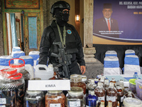 Indonesian National Narcotic Agency (BNN) officers are displaying evidence after a raid of a drug lab, during a press conference in Gianyar,...