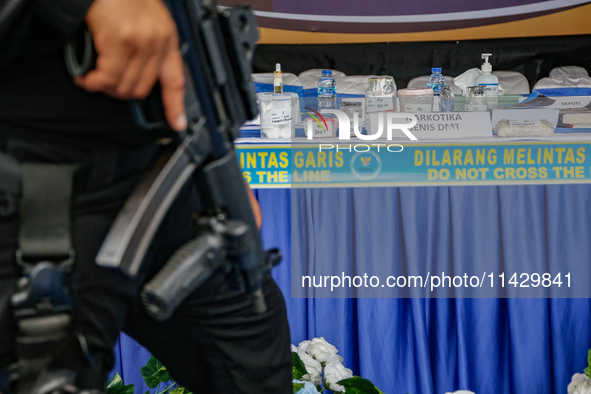 Indonesian National Narcotic Agency (BNN) officers are displaying evidence after a raid of a drug lab, during a press conference in Gianyar,...