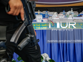 Indonesian National Narcotic Agency (BNN) officers are displaying evidence after a raid of a drug lab, during a press conference in Gianyar,...