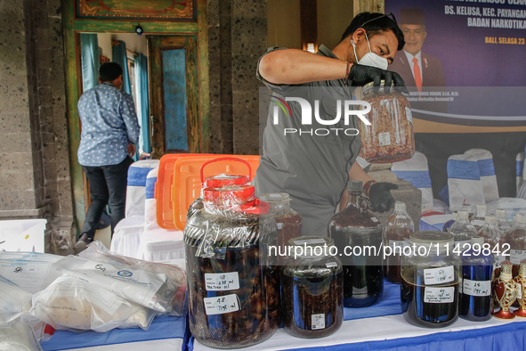 Indonesian National Narcotic Agency (BNN) officers are displaying evidence after a raid of a drug lab, during a press conference in Gianyar,...