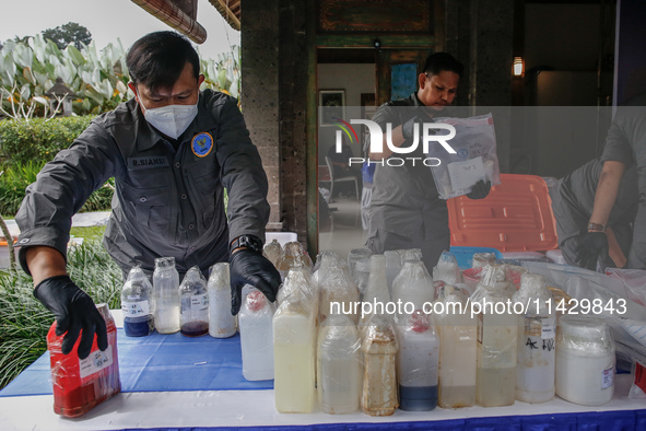 Indonesian National Narcotic Agency (BNN) officers are displaying evidence after a raid of a drug lab, during a press conference in Gianyar,...