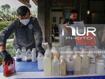 Indonesian National Narcotic Agency (BNN) officers are displaying evidence after a raid of a drug lab, during a press conference in Gianyar,...