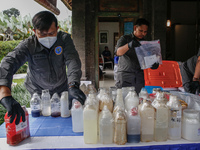 Indonesian National Narcotic Agency (BNN) officers are displaying evidence after a raid of a drug lab, during a press conference in Gianyar,...