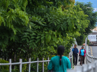 Nepali citizens are walking past the plants planted on the roadside that have turned clean and green after overnight rainfall, which is brin...