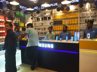 People are shopping inside a store selling mobile phones and accessories in Kolkata, India, on July 23, 2024. (