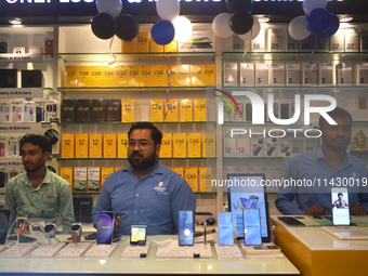 Sellers are waiting for customers inside a mobile shop in Kolkata, India, on July 23, 2024. (