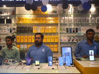 Sellers are waiting for customers inside a mobile shop in Kolkata, India, on July 23, 2024. (