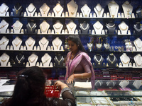 A woman is checking ornaments at a jewelry shop in Kolkata, India, on July 23, 2024. (