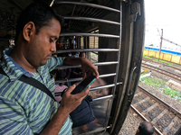 A passenger is watching his smartphone live streaming Union Finance Minister Nirmala Sitharaman's budget speech inside a general compartment...