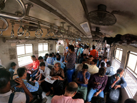 An Indian is traveling in a local train in the outskirts of Kolkata, India, on July 23, 2024. (