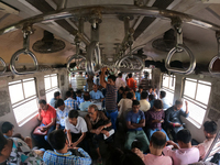 An Indian is traveling in a local train in the outskirts of Kolkata, India, on July 23, 2024. (