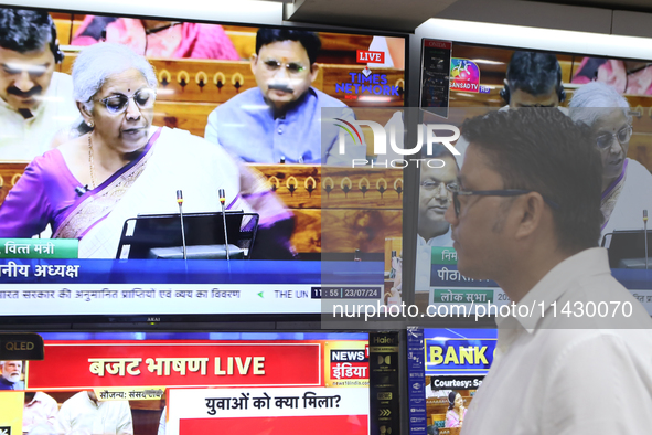 People are watching TV live as Union Finance Minister Nirmala Sitharaman addresses at an electronic shop in Kolkata, India, on July 23, 2024...