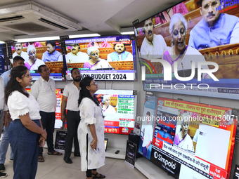 People are watching TV live as Union Finance Minister Nirmala Sitharaman addresses at an electronic shop in Kolkata, India, on July 23, 2024...